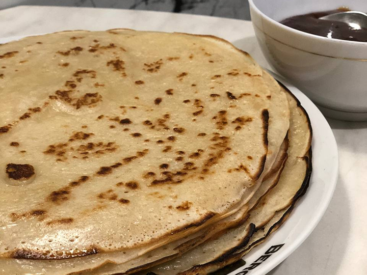 Блины на закваске и пиала с медом.